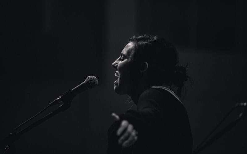 woman singing into mic