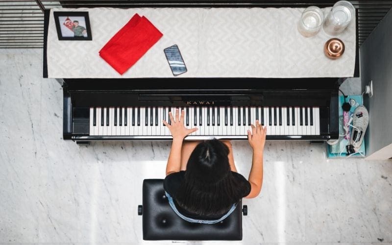 aerial shot of woman playing all piano chords