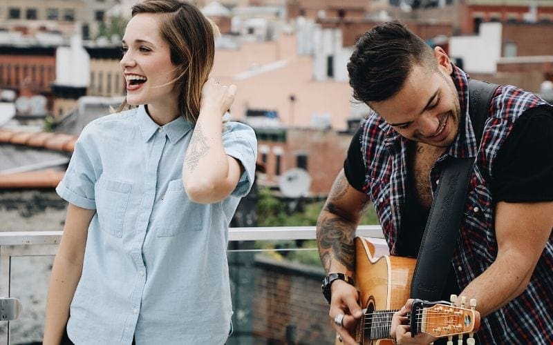 two musicians playing guitar and singing