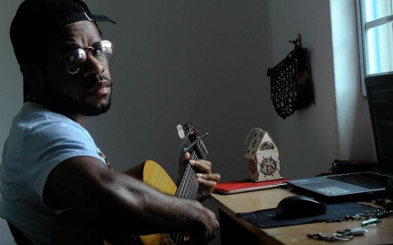 man playing the guitar songwriting