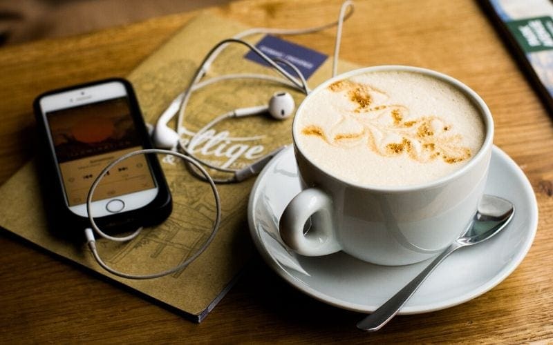 podcast on a phone in a coffee shop