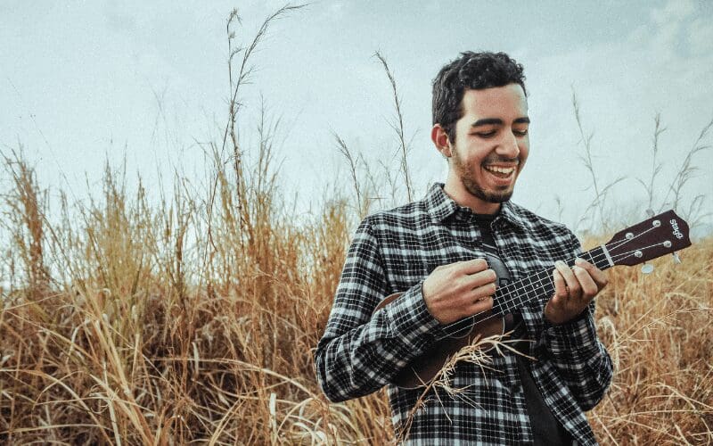 man playing ukulele