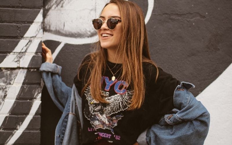 women wearing band tee, merchandise is part of a music branding strategy