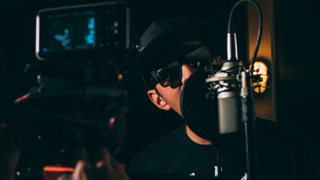 Man sings into a microphone in a studio